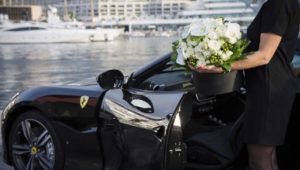 a big bouquet of flowers and luxury car